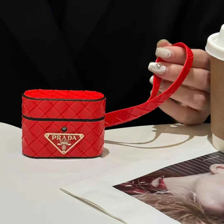 Prada - inspired barrel - shaped woven - pattern AirPods case with hand strap