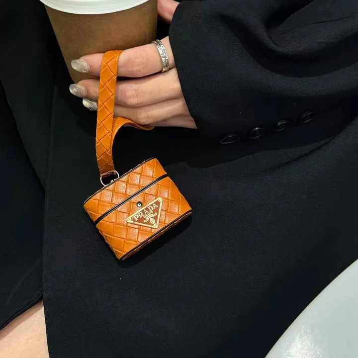 Prada - inspired barrel - shaped woven - pattern AirPods case with hand strap